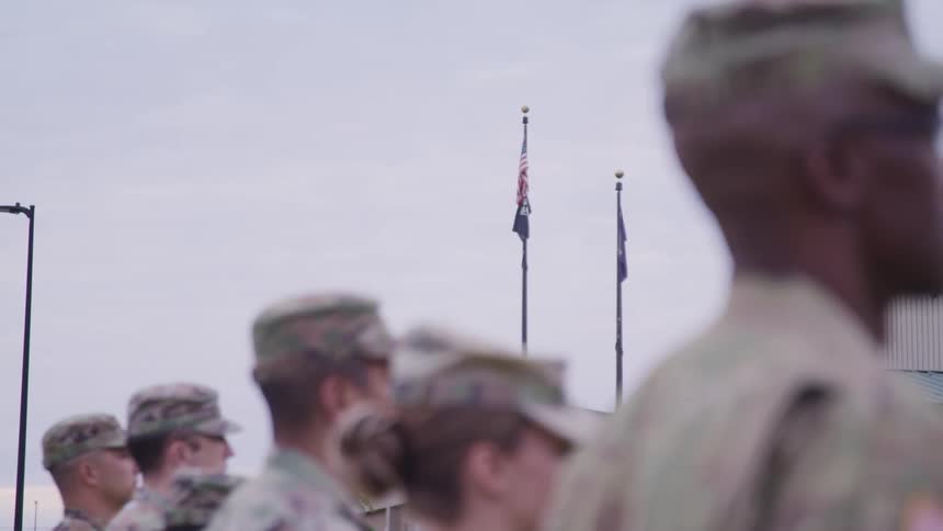 A row of soldiers stand and salute