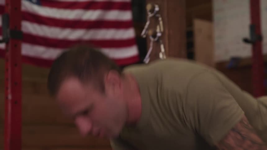A soldier does pushups indoors