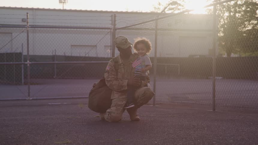 A soldier hugs his child