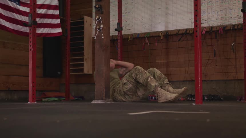A military man is working out in a room