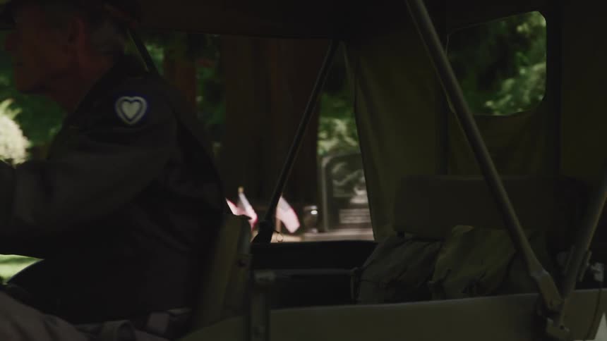 A veteran driving a vehicle in a cemetery
