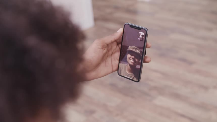 A person talking to a family member on a smartphone video chat
