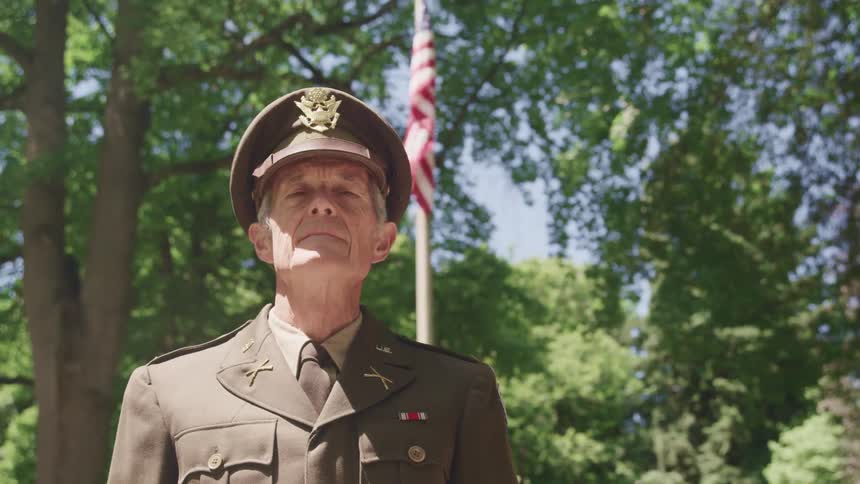 A man in a military uniform staring off into the distance