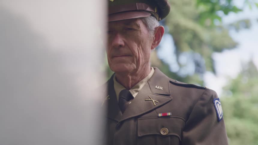 Veteran elderly military officer in uniform stands still outdoors