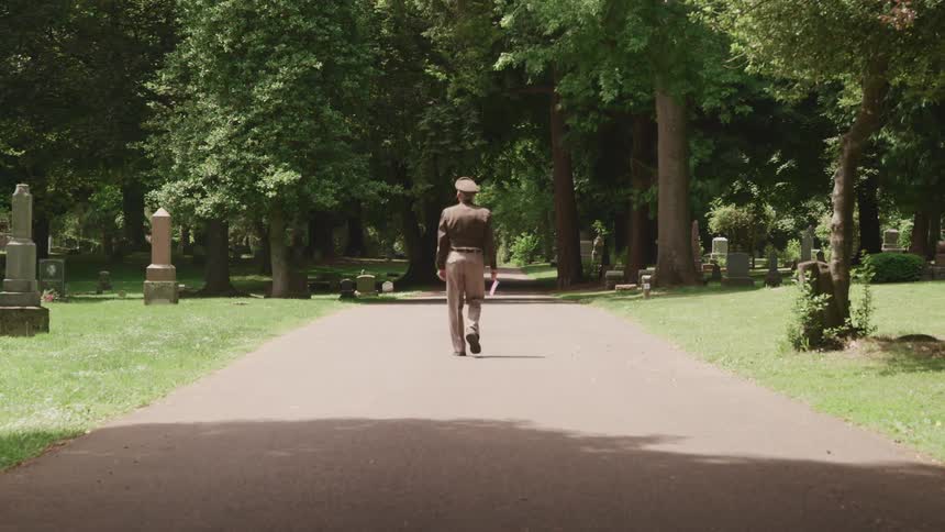 A veteran walks through a cemetary