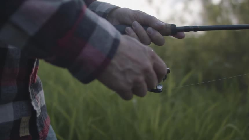 A person wheeling in a fishing rod