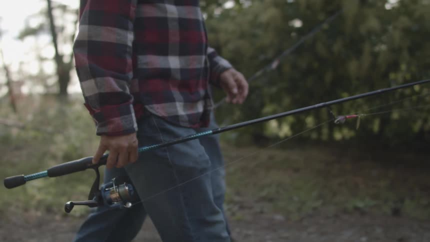 Two men walking down a path with fishing poles