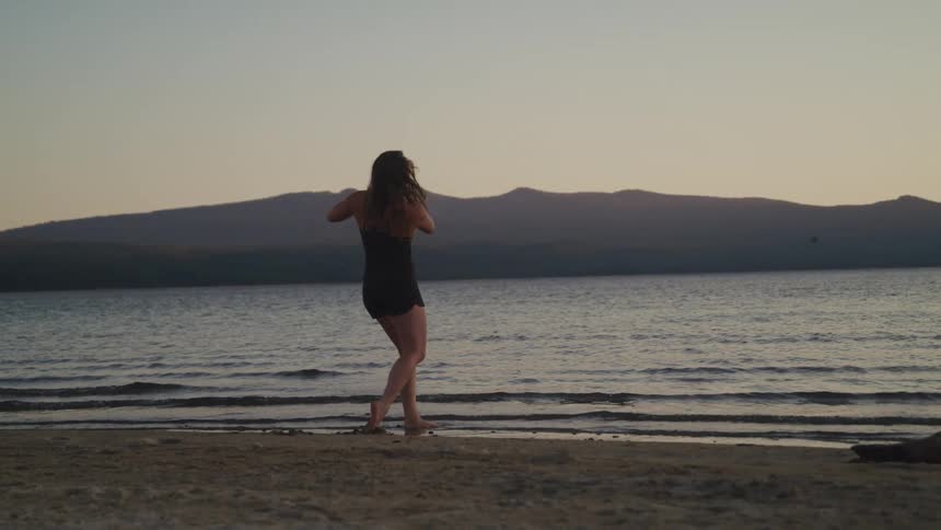 A woman throwing rocks into water