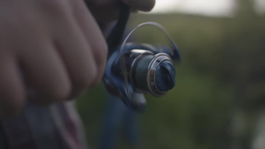 A person is reeling in their fishing pole