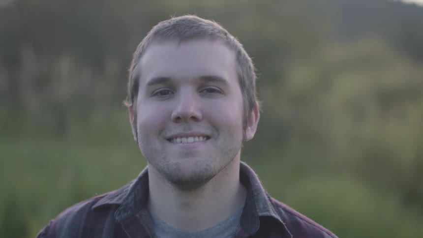 A man smiling and looking at the camera