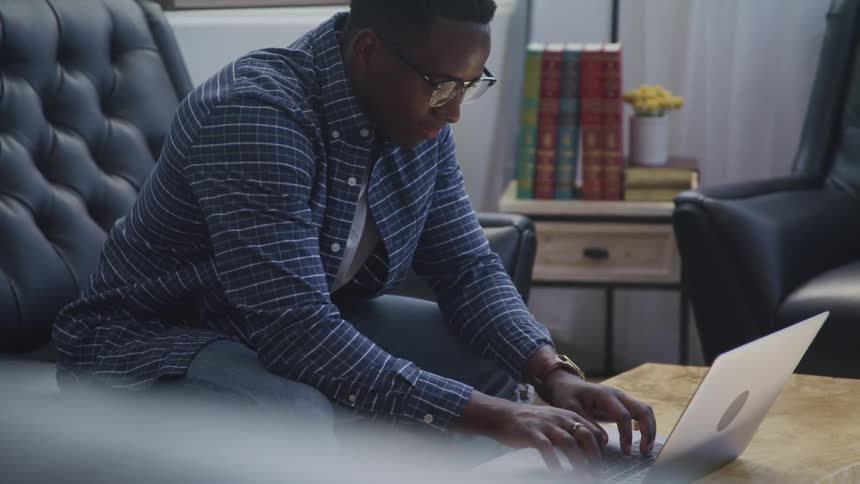 A man typing on a laptop