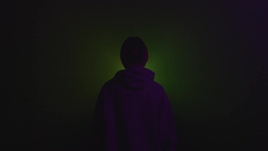 A person is standing in a fog filled room