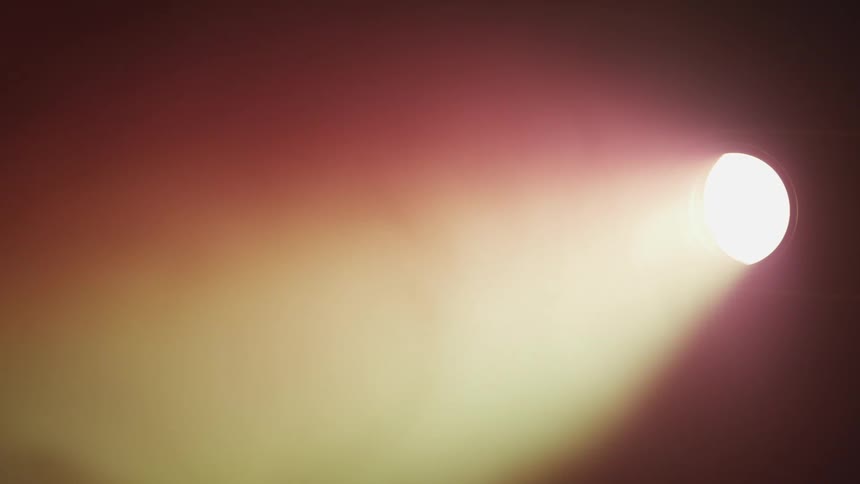 Dust or smoke swirl in a light beam