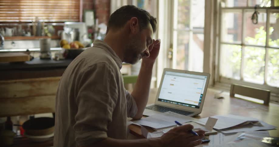 A man sitting at a table going over paperwork