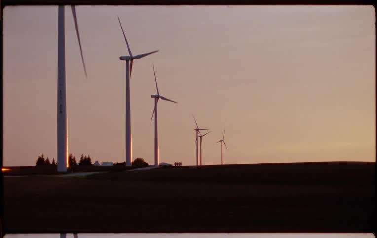 Windmills are circulating power outdoors in a rural area