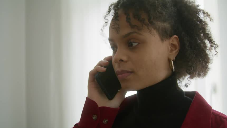A woman talking on her cell phone and smiling