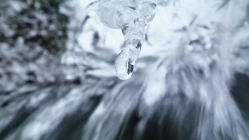 A waterfall with ice melting