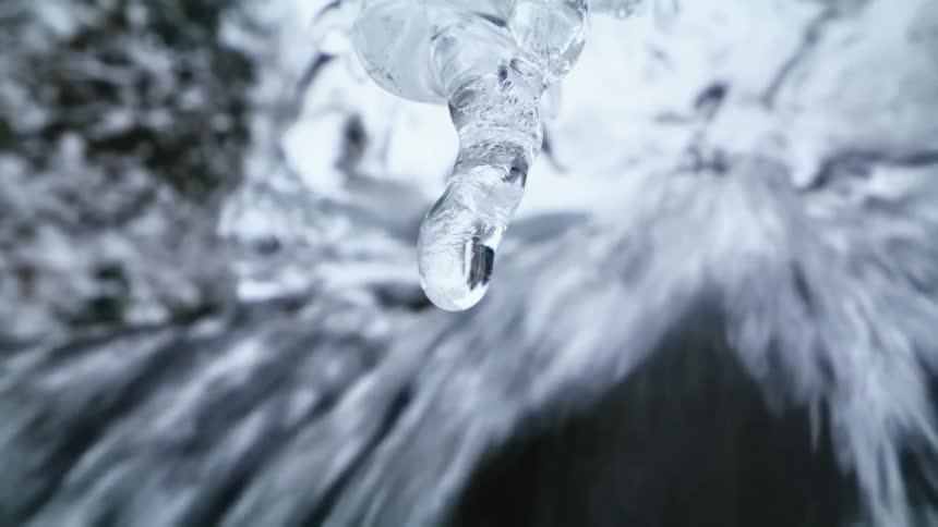 A waterfall with ice melting