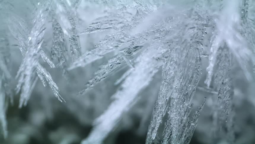 Translucent ice crystals form sharp points and ragged edges