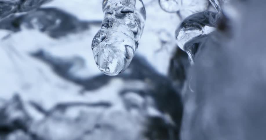 Ice melts into a fast moving puddle below