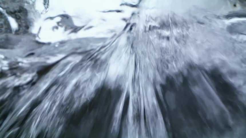 The water pours over the ice fast