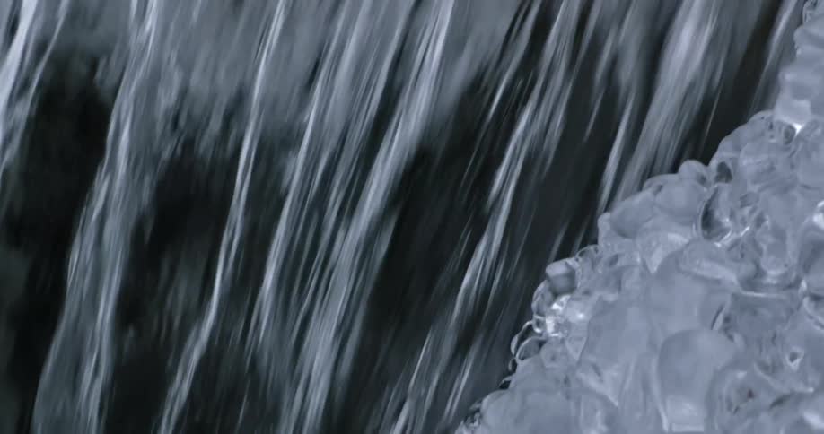 A waterfall is flowing in winter during the day