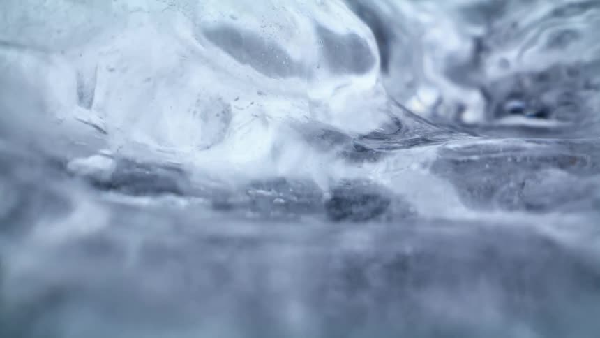 A clear liquid moves under a smooth clear surface