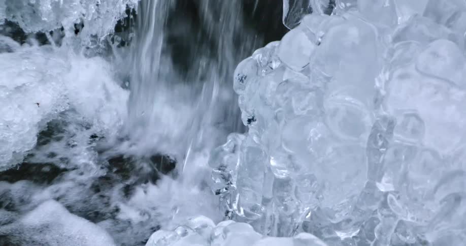 A waterfall with ice melting