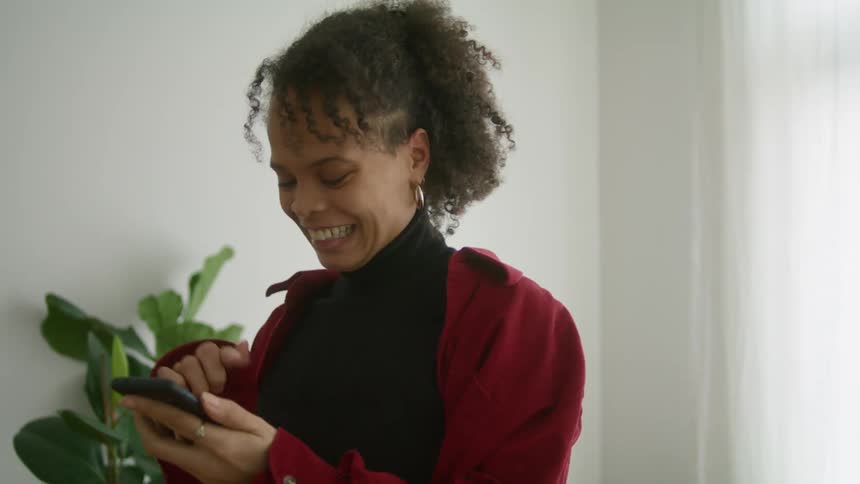 A woman hangs up the phone and cheers