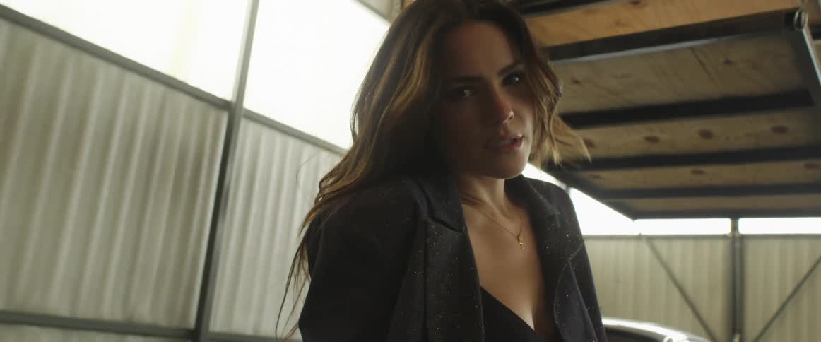 Young long haired woman inside a warehouse modeling for the camera