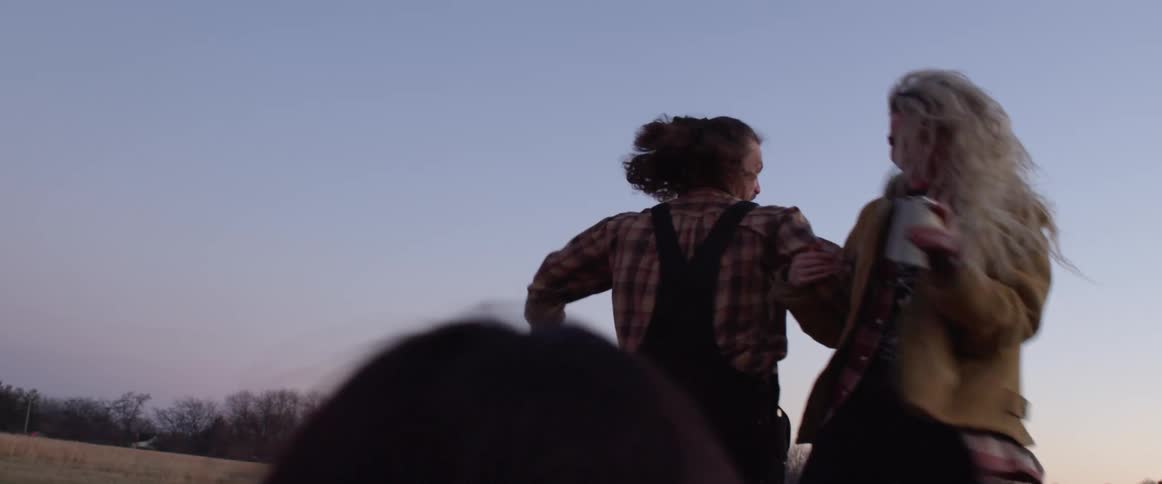 A woman and man are dancing outdoors together