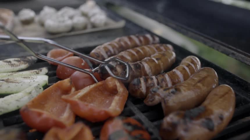 Meat is being flipped on a grill