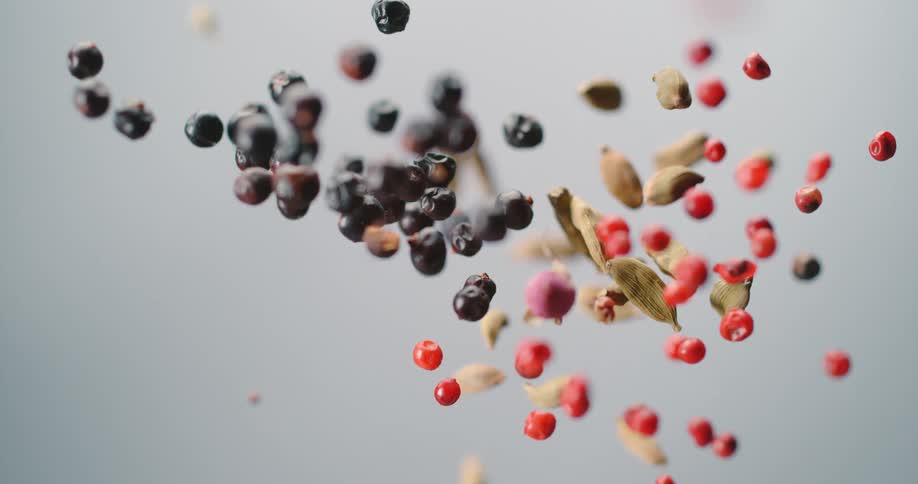 Grains and seeds bouncing up and falling down on a white background