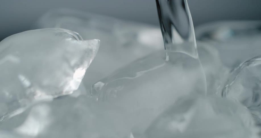 Water being poured over ice cubes