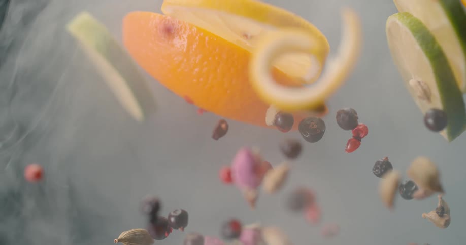 Citrus and berries being tossed up in the smoke