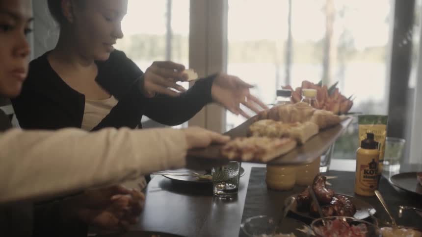 A plate of food is passed down a table