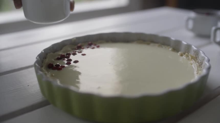 A person decorates a pie