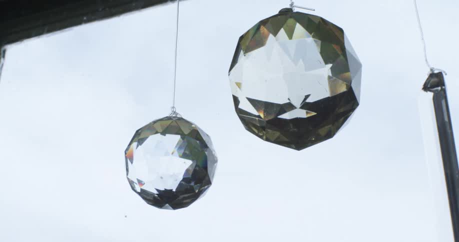 Crystal decorations hang in a window of a home