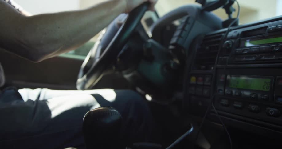 A man driving a car on a sunny day