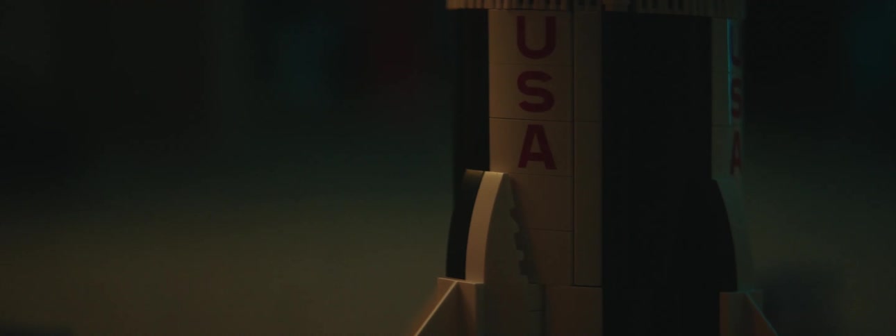 Close up of a toy model of a rocket on the night stand in a bedroom at night