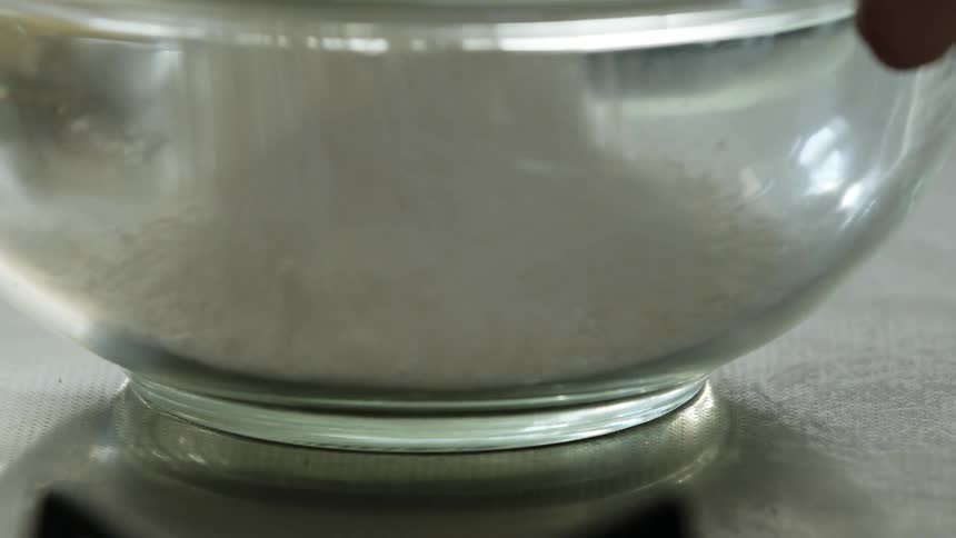 Flour falling into a mixing bowl