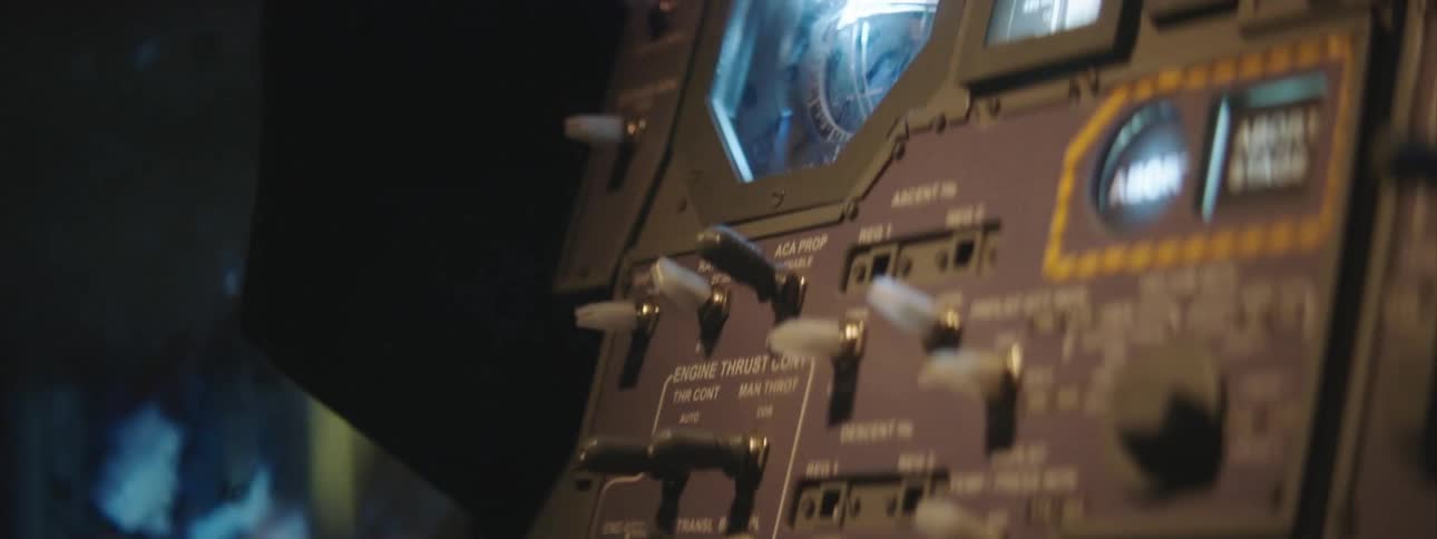 Strobing lights over a shaking control panel of an aircraft at night