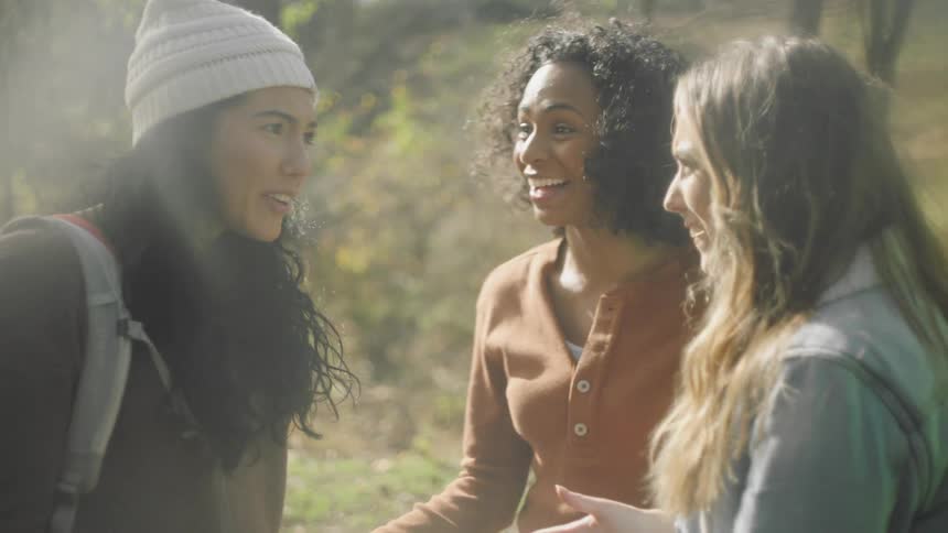 Three women are hiking together outdoors