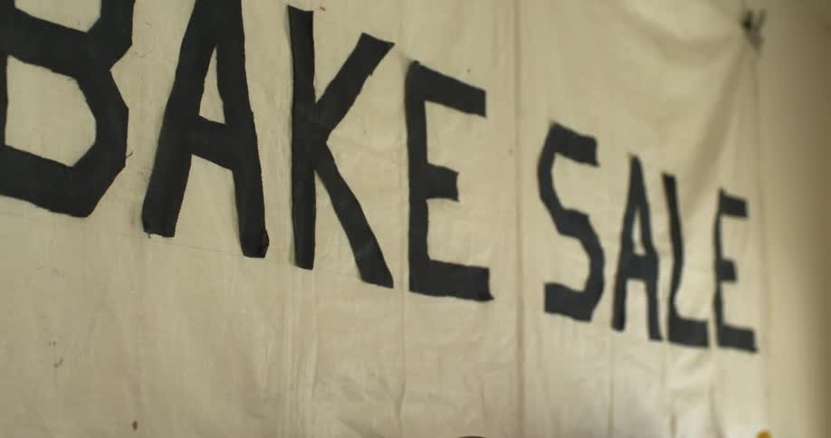 Bake sale sign banner hanging on the wall inside a room