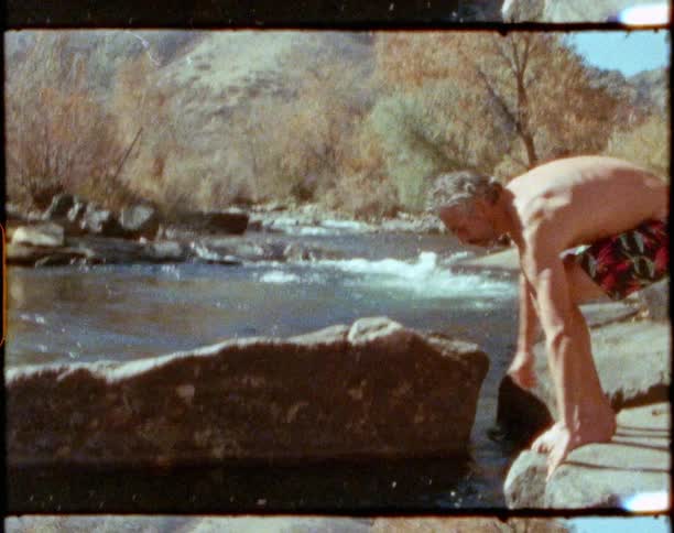 A man enters the spring on a sunny day