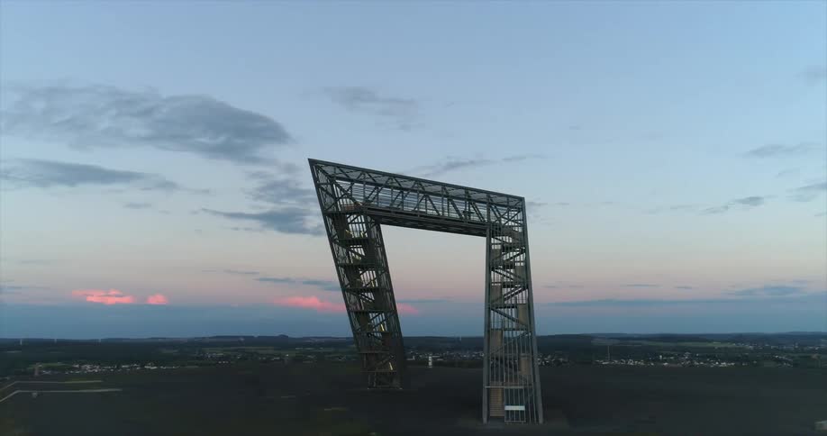 A structure with the landscape with buildings the sky and clouds in the background