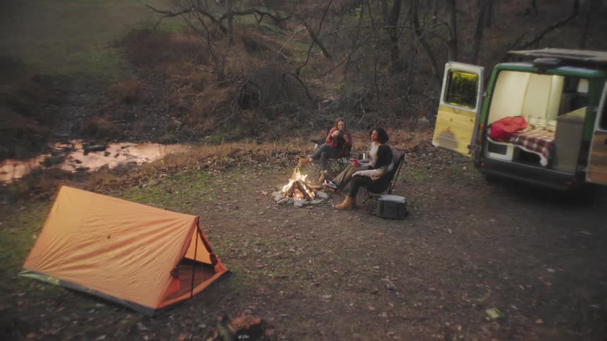 People sit around the campfire talking