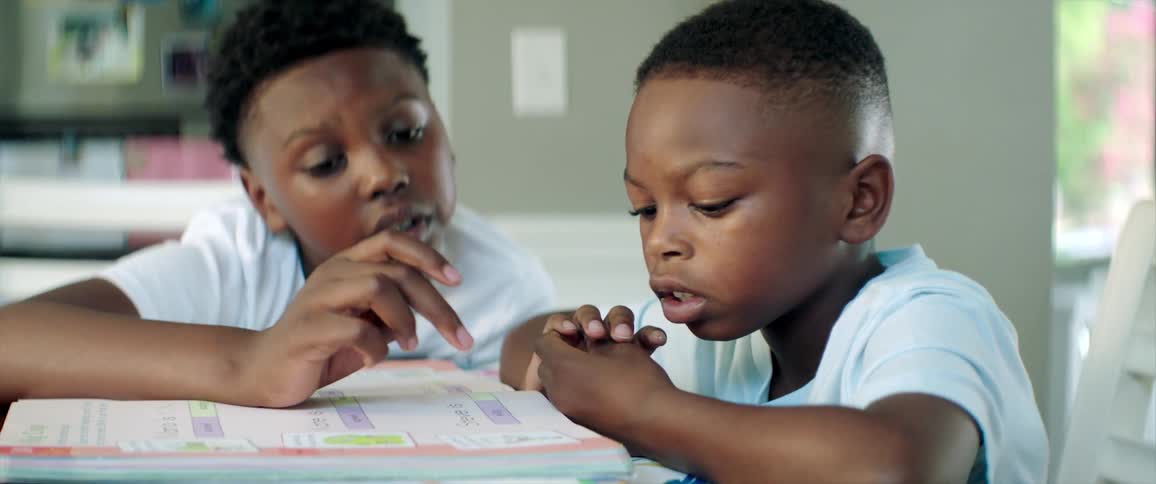 Two students looking at information in a book
