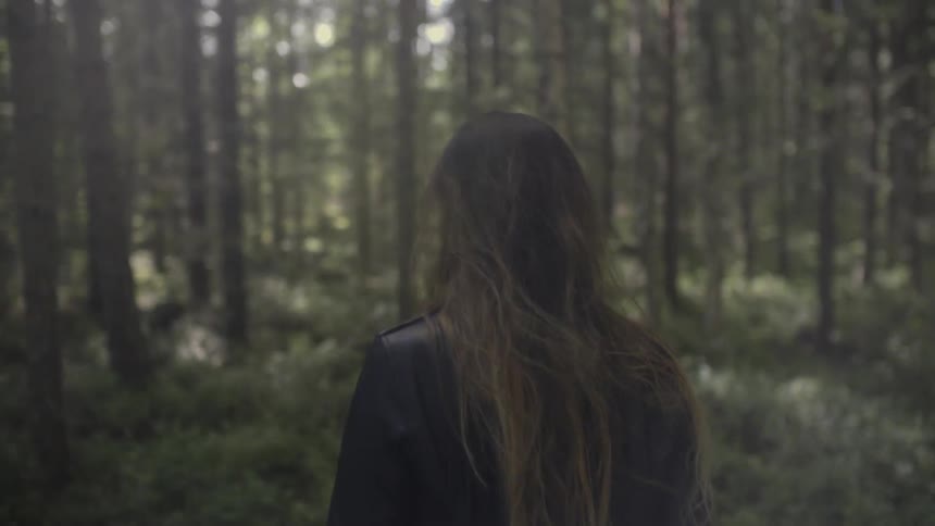 Woman walks through a forest