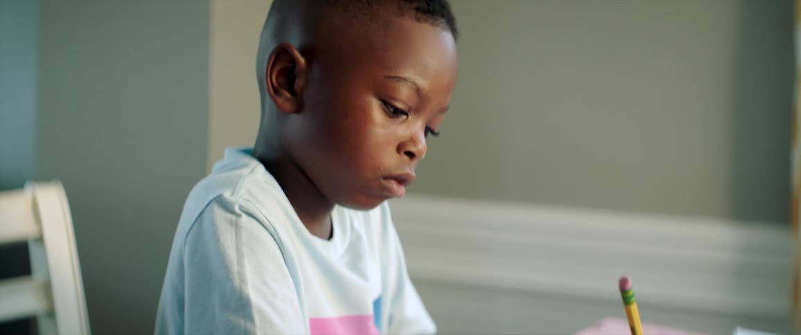 A child sitting at a table doing homework